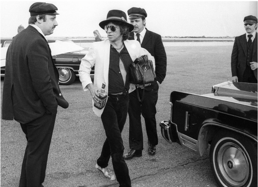 "Keith Richards, Holding a Bottle of Jack Daniels, Midwest Airport, 1979" Henry Diltz silver gelatin print, edition #103/275